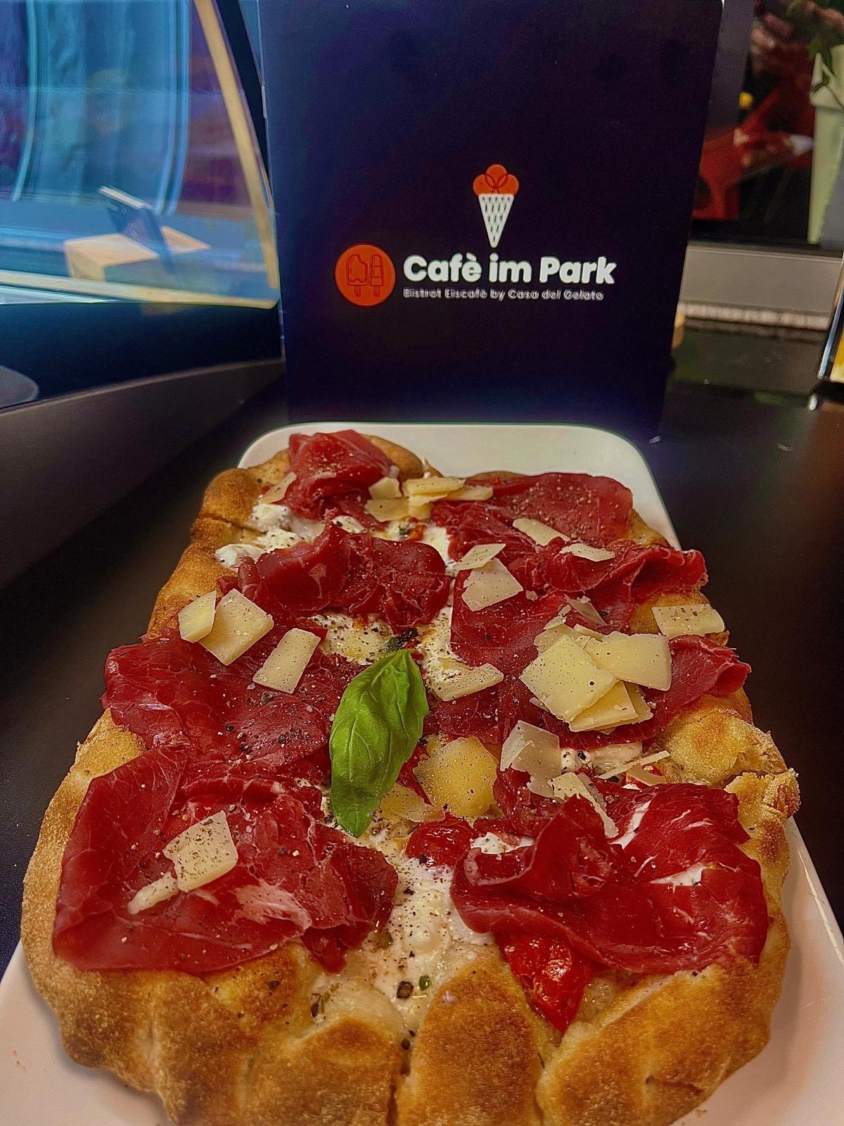 Barista bereitet Cappuccino mit Herzchen-Latteart zu